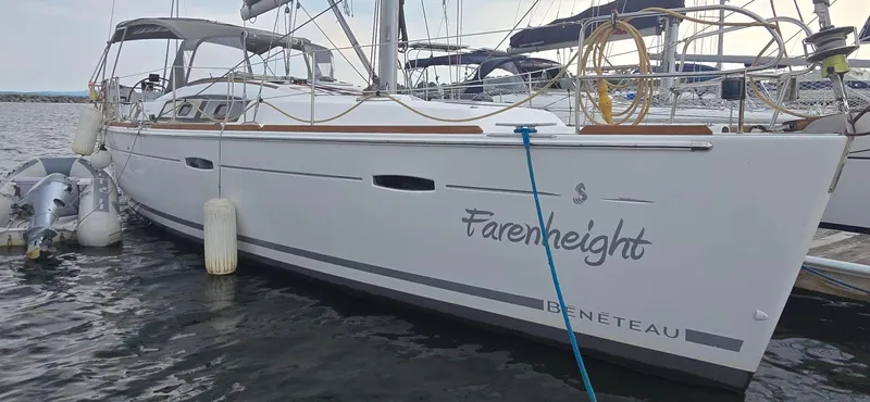 Farenheight Yacht Photos Pics 2008 Beneteau Oceanis 40 sailboat docked, named "Farenheight," with visible fenders and dinghy.