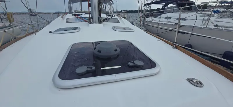 Farenheight Yacht Photos Pics 2008 Beneteau Oceanis 40 sailboat deck with hatches, docked alongside other boats.