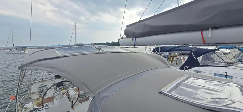 Farenheight Yacht Photos Pics 2008 Beneteau Oceanis 40 sailboat with solar panels, docked in a marina.