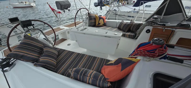 Farenheight Yacht Photos Pics Beneteau Oceanis 40 sailboat cockpit with striped cushions, dual steering wheels, and nautical ropes, 2008 model.