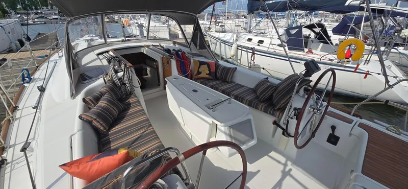 Farenheight Yacht Photos Pics 2008 Beneteau Oceanis 40 sailboat cockpit with striped cushions, docked at marina.