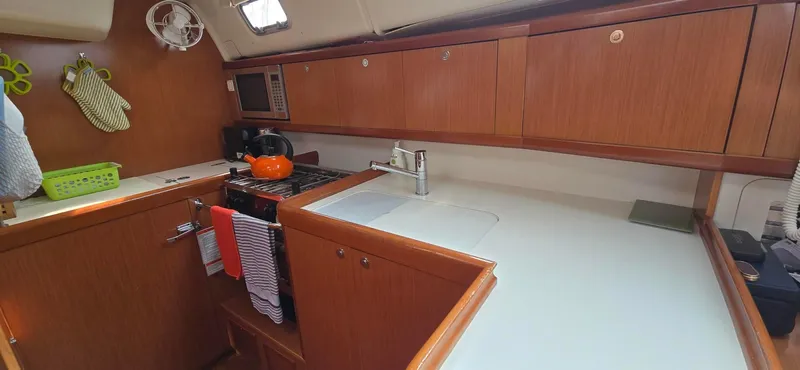 Farenheight Yacht Photos Pics Interior of 2008 Beneteau Oceanis 40 yacht kitchen with wooden cabinets and modern appliances.