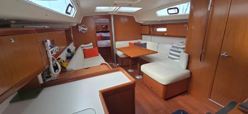 Farenheight Yacht Photos Pics Interior of 2008 Beneteau Oceanis 40 sailboat with wood finish and cozy seating area.