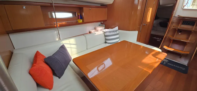 Farenheight Yacht Photos Pics Interior of 2008 Beneteau Oceanis 40 yacht with cozy seating and wooden table.