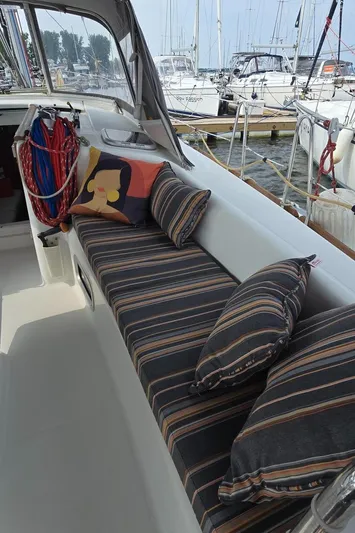 Farenheight Yacht Photos Pics Cozy seating area on 2008 Beneteau Oceanis 40 sailboat with striped cushions and decorative pillows.