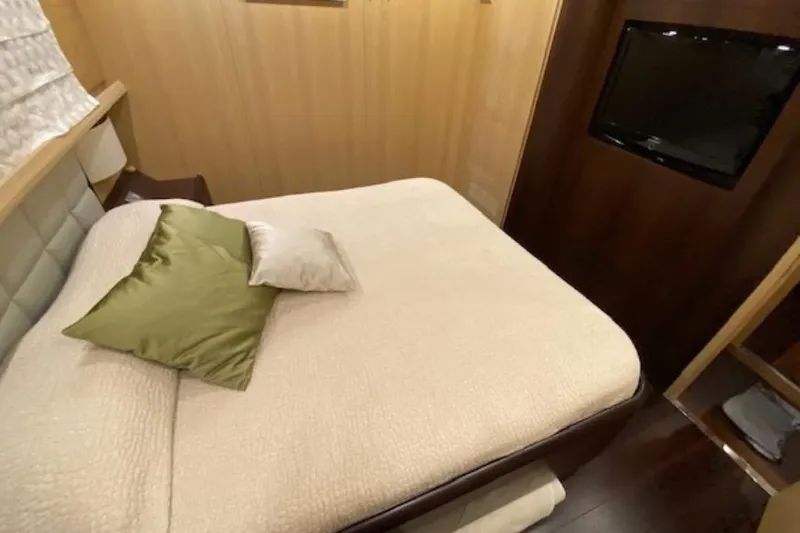  Yacht Photos Pics Luxurious bedroom interior of 2010 Maiora MAIORA 27 yacht with cozy bedding and TV.