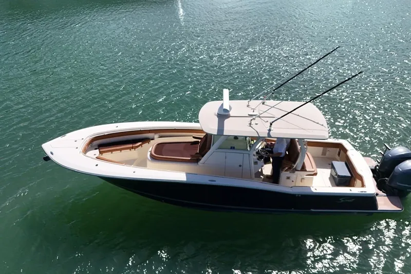  Yacht Photos Pics 2015 Scout 350 LXF boat cruising on clear water, side view.