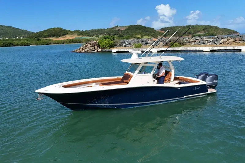  Yacht Photos Pics 2015 Scout 350 LXF boat cruising on a scenic lake with lush green hills.