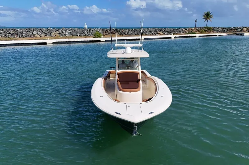  Yacht Photos Pics 2015 Scout 350 LXF boat on calm water with clear sky background.