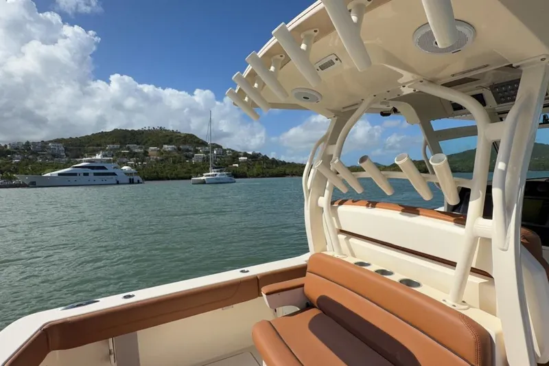  Yacht Photos Pics 2015 Scout 350 LXF boat interior with rod holders, scenic marina view.