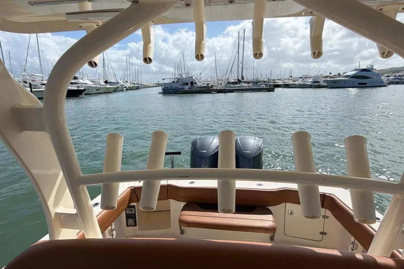  Yacht Photos Pics 2015 Scout 350 LXF boat with rod holders, docked in a marina with yachts.