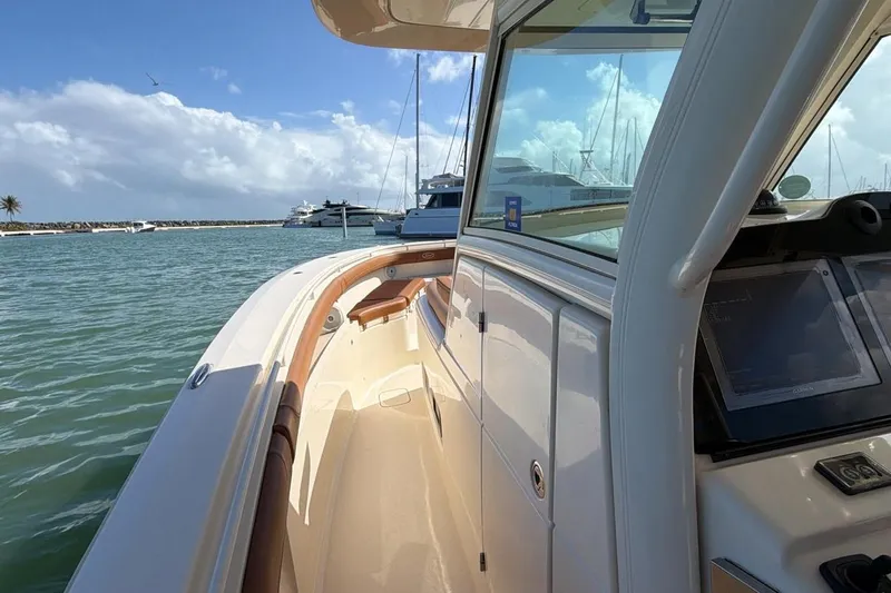  Yacht Photos Pics 2015 Scout 350 LXF boat docked, featuring sleek design and modern navigation system.