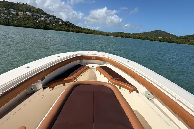  Yacht Photos Pics 2015 Scout 350 LXF boat cruising on a scenic lake with lush hills.