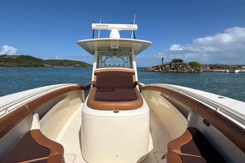  Yacht Photos Pics 2015 Scout 350 LXF boat on water, featuring brown seating and Garmin equipment.