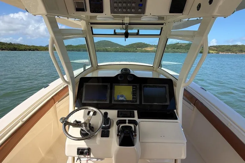  Yacht Photos Pics Cockpit view of 2015 Scout 350 LXF boat with navigation screens and steering wheel.