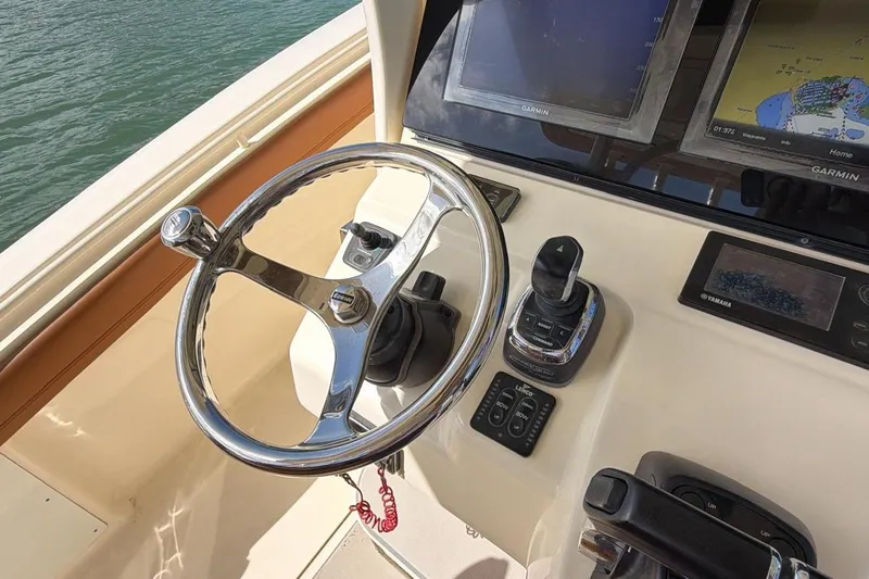  Yacht Photos Pics Steering console of 2015 Scout 350 LXF boat with navigation screens and controls.
