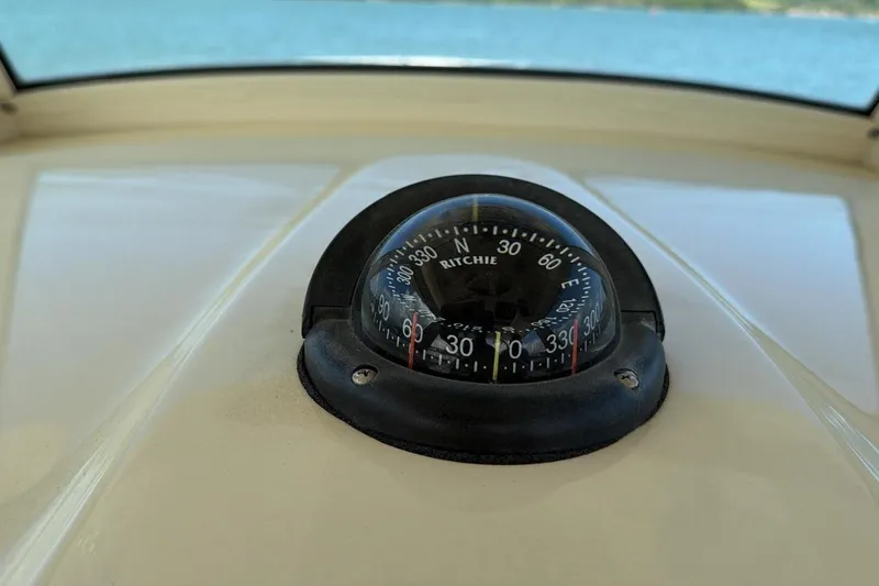  Yacht Photos Pics Compass on 2015 Scout 350 LXF boat dashboard, overlooking water.