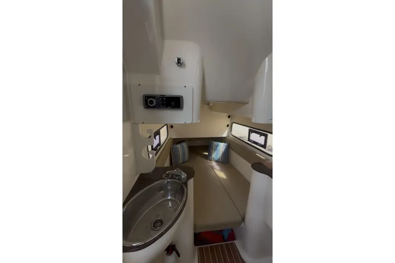  Yacht Photos Pics Interior of 2015 Scout 350 LXF boat with sink, seating, and windows.