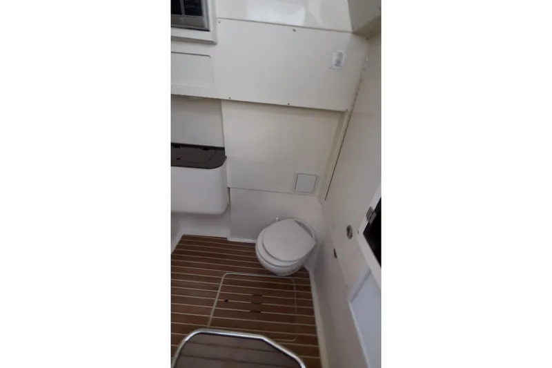  Yacht Photos Pics 2015 Scout 350 LXF boat interior with toilet and wooden flooring.