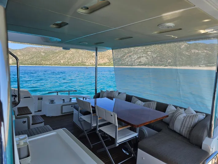 Murano Yacht Photos Pics Luxurious Azimut 72 FLY yacht interior with ocean view, featuring elegant seating and dining area.