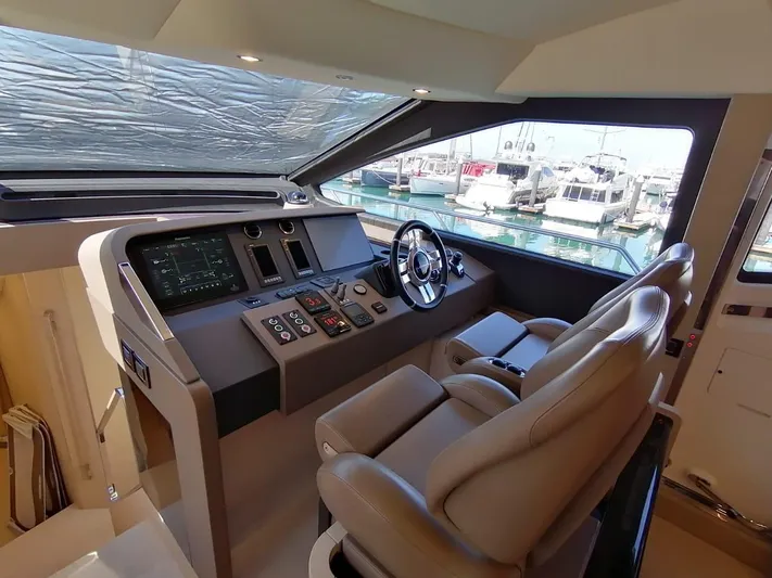 Murano Yacht Photos Pics Helm of 2018 Azimut 72 FLY yacht with modern controls and leather seating.