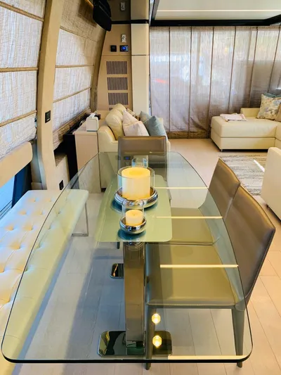 Murano Yacht Photos Pics Luxurious interior of 2018 Azimut 72 FLY yacht with elegant glass dining table.