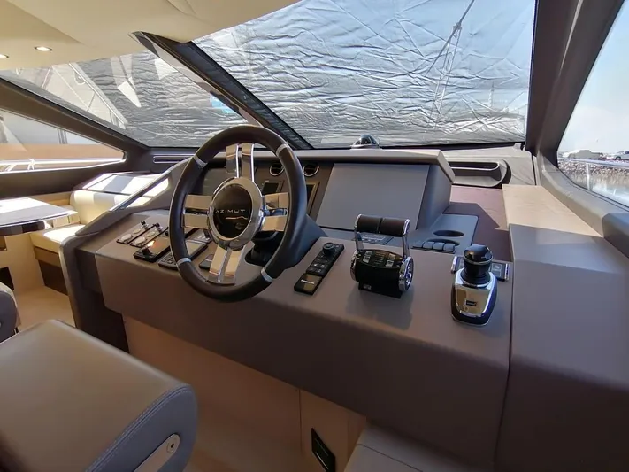 Murano Yacht Photos Pics Helm of 2018 Azimut 72 FLY yacht with modern controls and steering wheel.