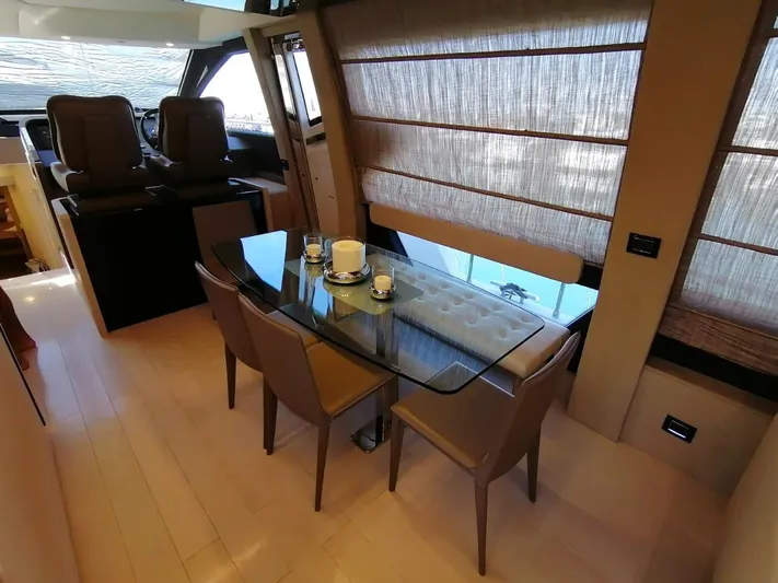 Murano Yacht Photos Pics Interior of 2018 Azimut 72 FLY yacht with elegant dining area and glass table.