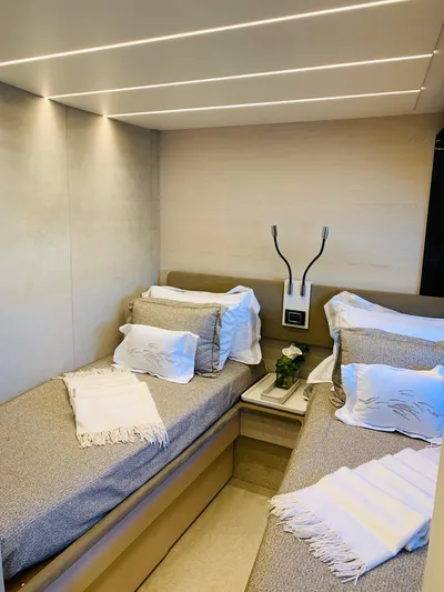 Murano Yacht Photos Pics Luxurious twin cabin interior of 2018 Azimut 72 FLY yacht, featuring elegant bedding and modern lighting.