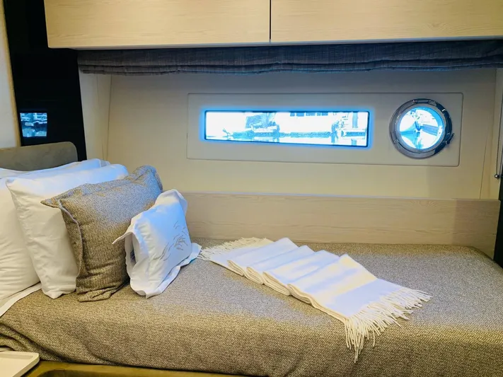 Murano Yacht Photos Pics Luxurious cabin interior of 2018 Azimut 72 FLY yacht with cozy bedding and window view.