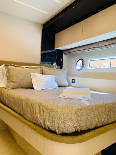 Murano Yacht Photos Pics Luxurious bedroom interior of 2018 Azimut 72 FLY yacht with elegant bedding and porthole window.