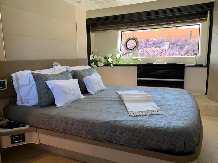 Murano Yacht Photos Pics Luxurious bedroom interior of 2018 Azimut 72 FLY yacht with elegant bedding and window view.
