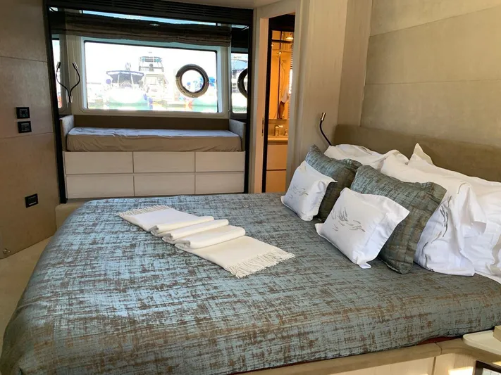 Murano Yacht Photos Pics Luxurious bedroom interior of 2018 Azimut 72 FLY yacht with elegant bedding and porthole view.