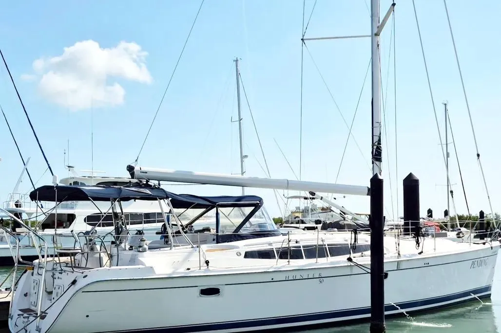 2012 Hunter Aft Cockpit 50 sailboat docked at marina under clear blue sky.