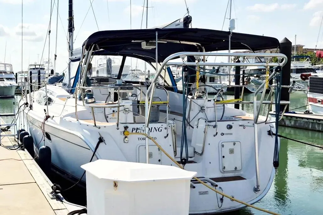 2012 Hunter Aft Cockpit 50 yacht docked in a marina, rear view.