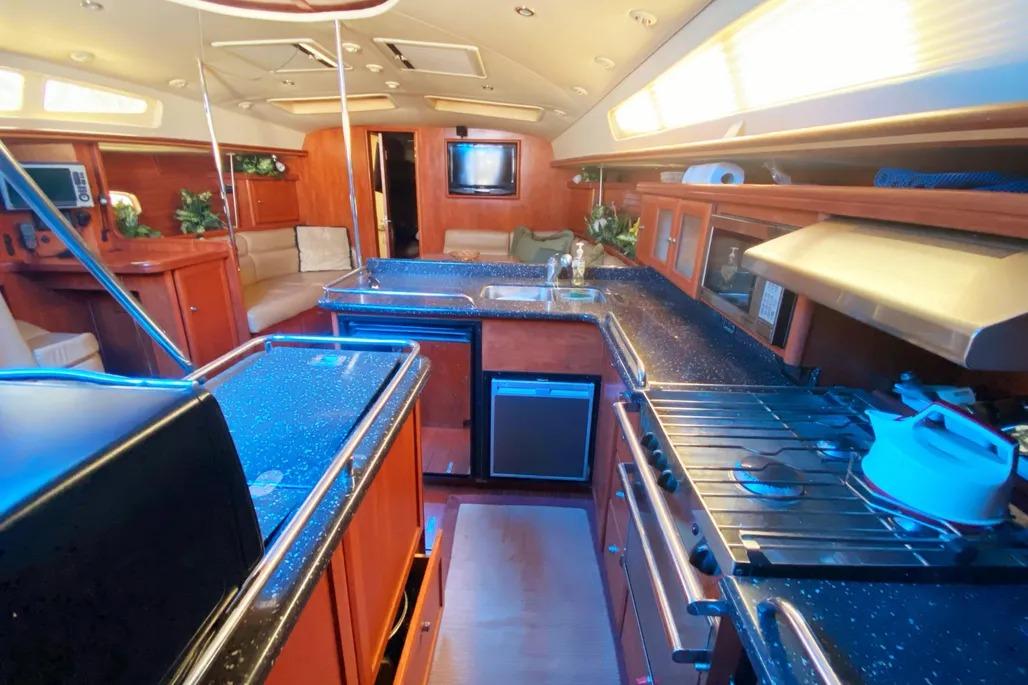 Luxurious interior of 2012 Hunter Aft Cockpit 50 yacht with modern kitchen amenities.