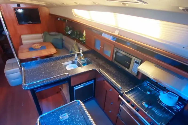 Pending Yacht Photos Pics Luxurious interior of 2012 Hunter Aft Cockpit 50 yacht with modern kitchen and seating area.
