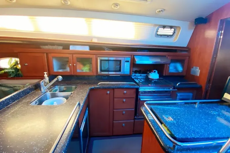 Pending Yacht Photos Pics Luxurious 2012 Hunter Aft Cockpit 50 yacht kitchen with modern amenities and sleek design.