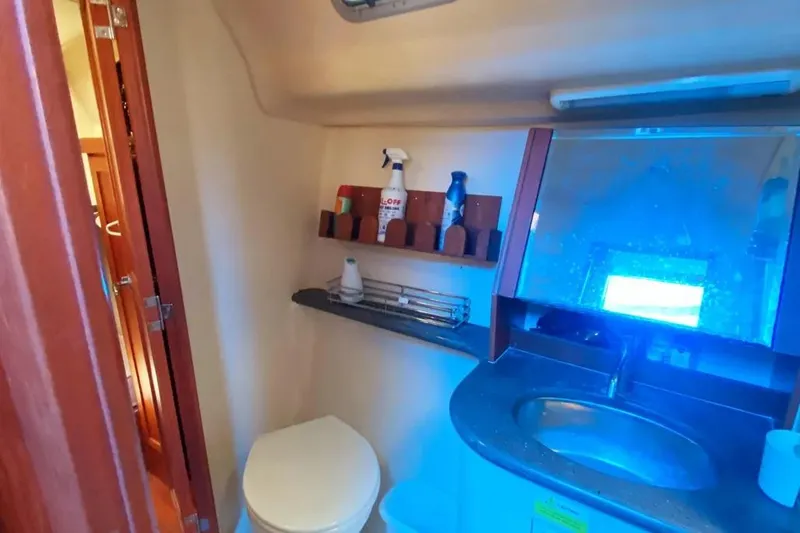 Pending Yacht Photos Pics 2012 Hunter Aft Cockpit 50 yacht bathroom with sink, mirror, and storage shelves.