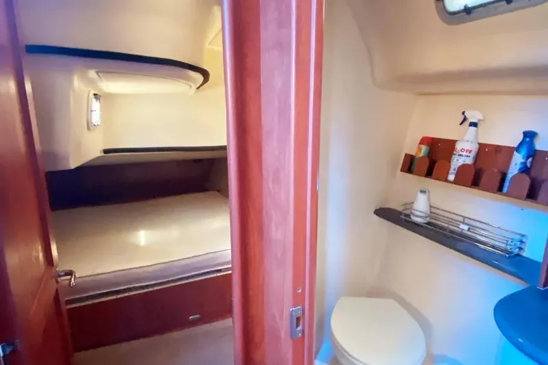 Pending Yacht Photos Pics Interior of 2012 Hunter Aft Cockpit 50 yacht, featuring a cozy cabin and compact bathroom.