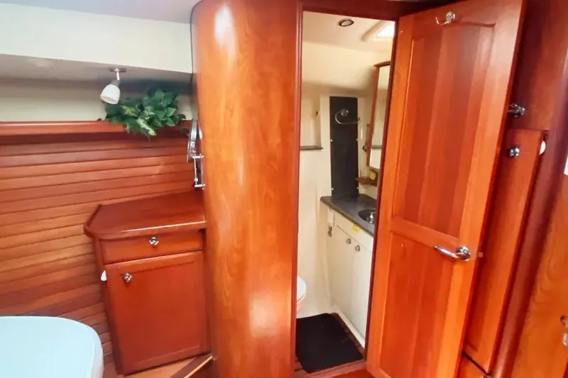 Pending Yacht Photos Pics Interior of 2012 Hunter Aft Cockpit 50 yacht with wooden cabinetry and bathroom.