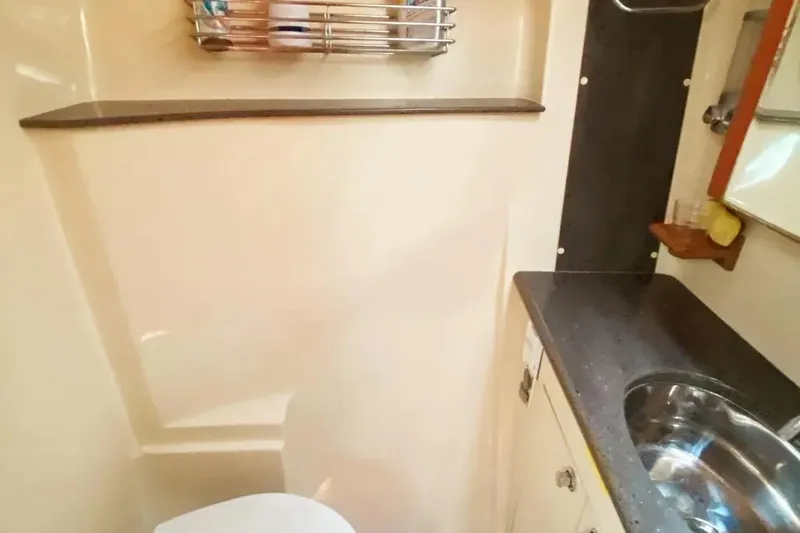 Pending Yacht Photos Pics Compact bathroom in 2012 Hunter Aft Cockpit 50 yacht with sink and storage.