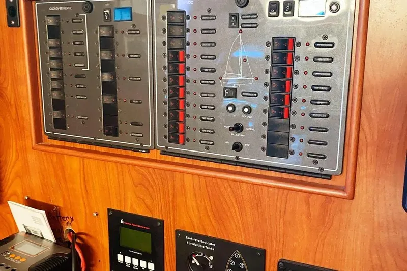 Pending Yacht Photos Pics Control panel of a 2012 Hunter Aft Cockpit 50 yacht, featuring various switches and indicators.