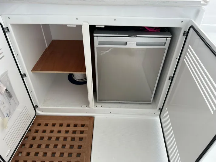  Yacht Photos Pics 2024 Lagoon 46 yacht interior storage with mini fridge and shelving.