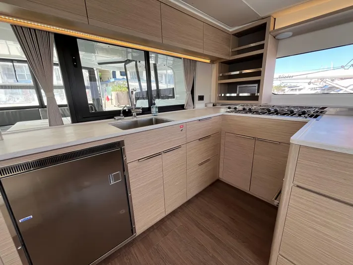  Yacht Photos Pics Modern kitchen interior of 2024 Lagoon 46 yacht with sleek cabinetry and appliances.