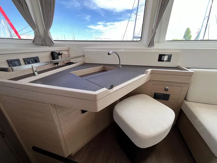  Yacht Photos Pics 2024 Lagoon 46 yacht interior with modern navigation station and comfortable seating.