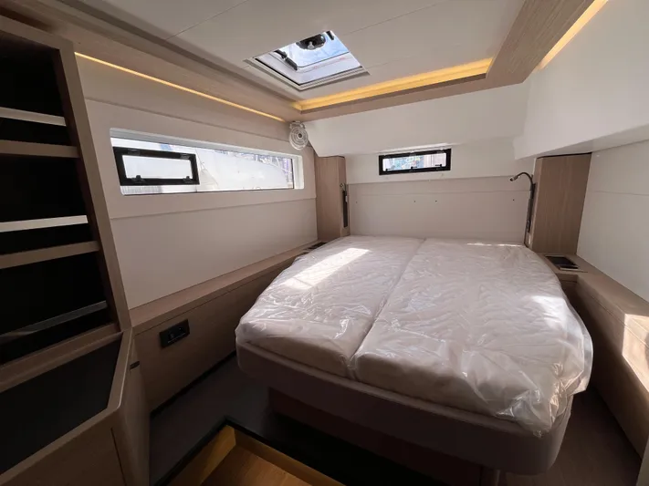  Yacht Photos Pics 2024 Lagoon 46 yacht interior cabin with bed, skylight, and modern design.