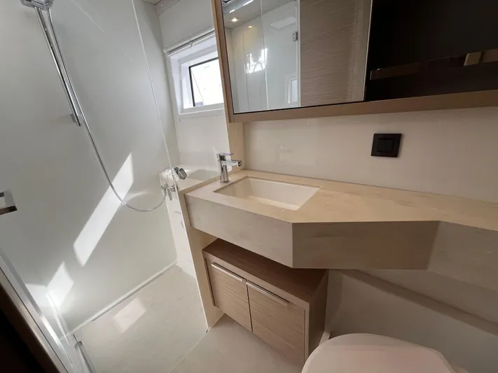  Yacht Photos Pics Modern bathroom in 2024 Lagoon 46 yacht with sleek fixtures and ample storage.