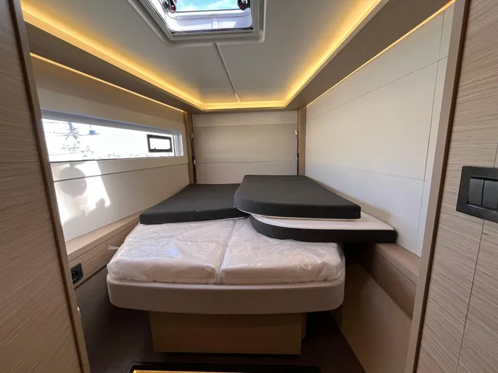  Yacht Photos Pics 2024 Lagoon 46 yacht interior cabin with modern lighting and comfortable bedding.
