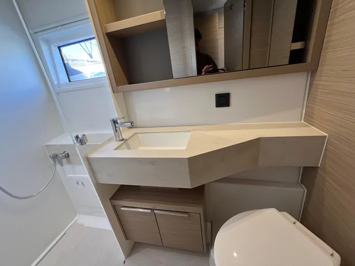  Yacht Photos Pics Modern bathroom in 2024 Lagoon 46 yacht with sleek sink and storage.
